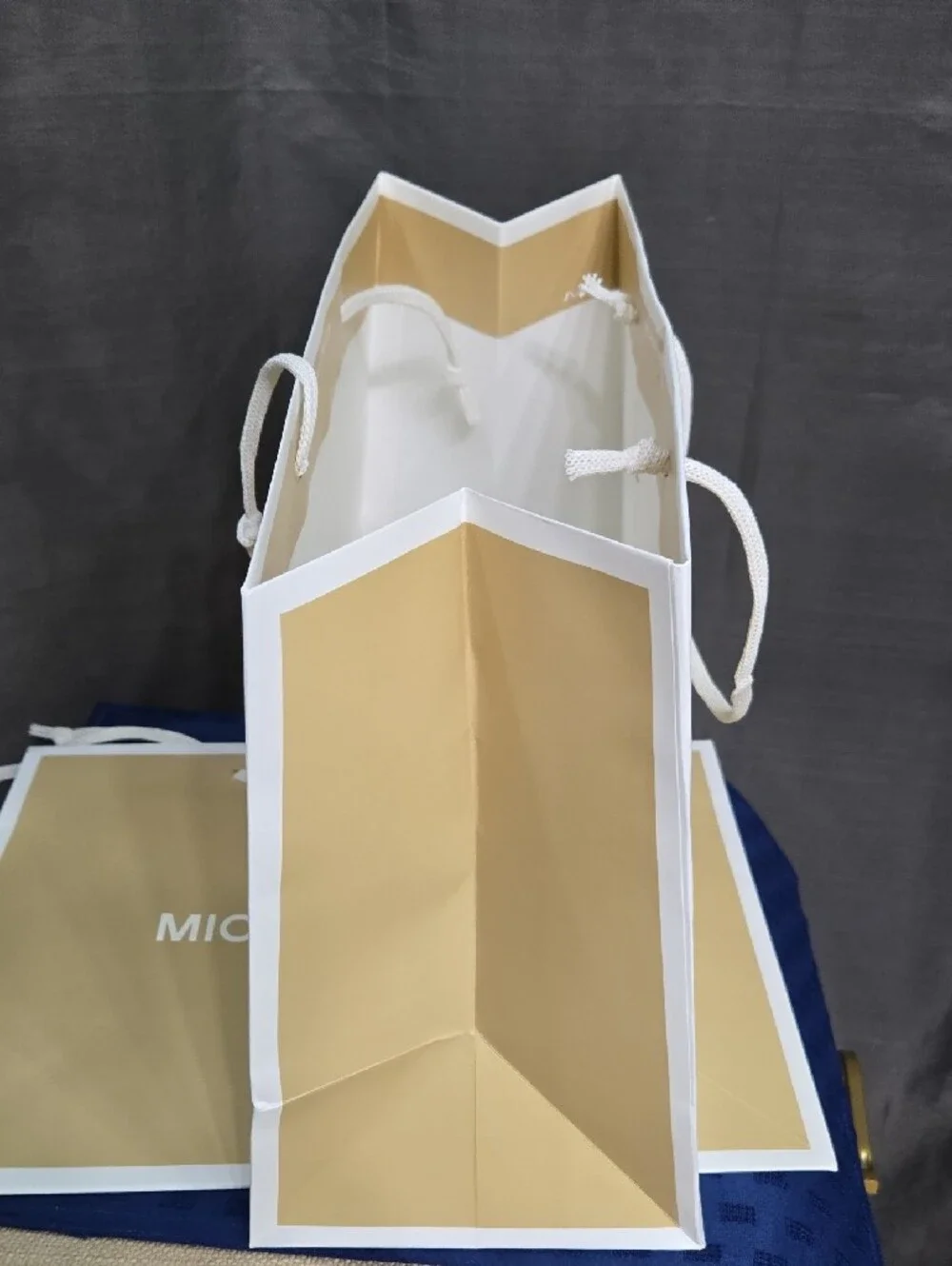 (2) Michael Kors Tan and White Rope-Handle Shopping Bag